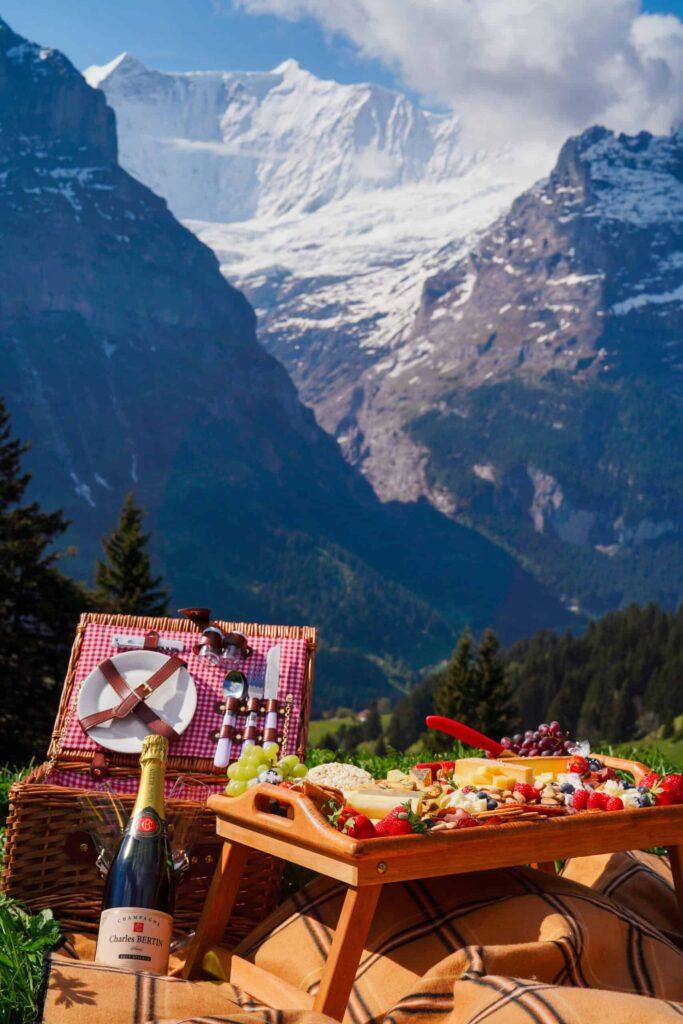 Luxury picnic setup in Grindelwald with a scenic view of the Eiger mountain, perfect for a Swiss Alps proposal