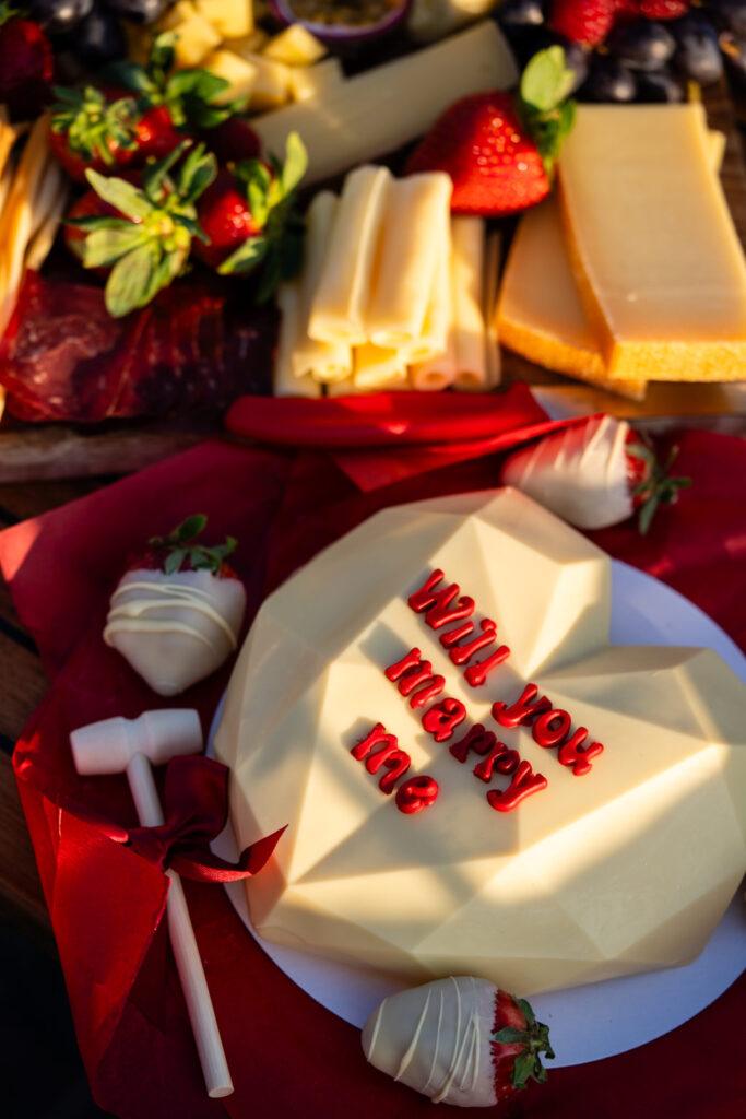 Cheese board and chocolate heart with Will You Marry Me text