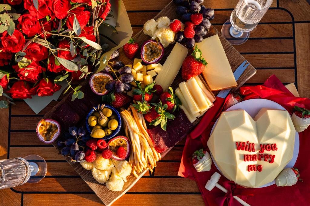 Full engagement snack board with Swiss cheese and berries on boat