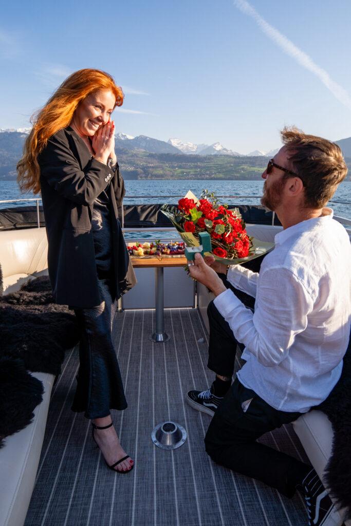 Surprise proposal on private boat cruise with bouquet and Swiss snacks