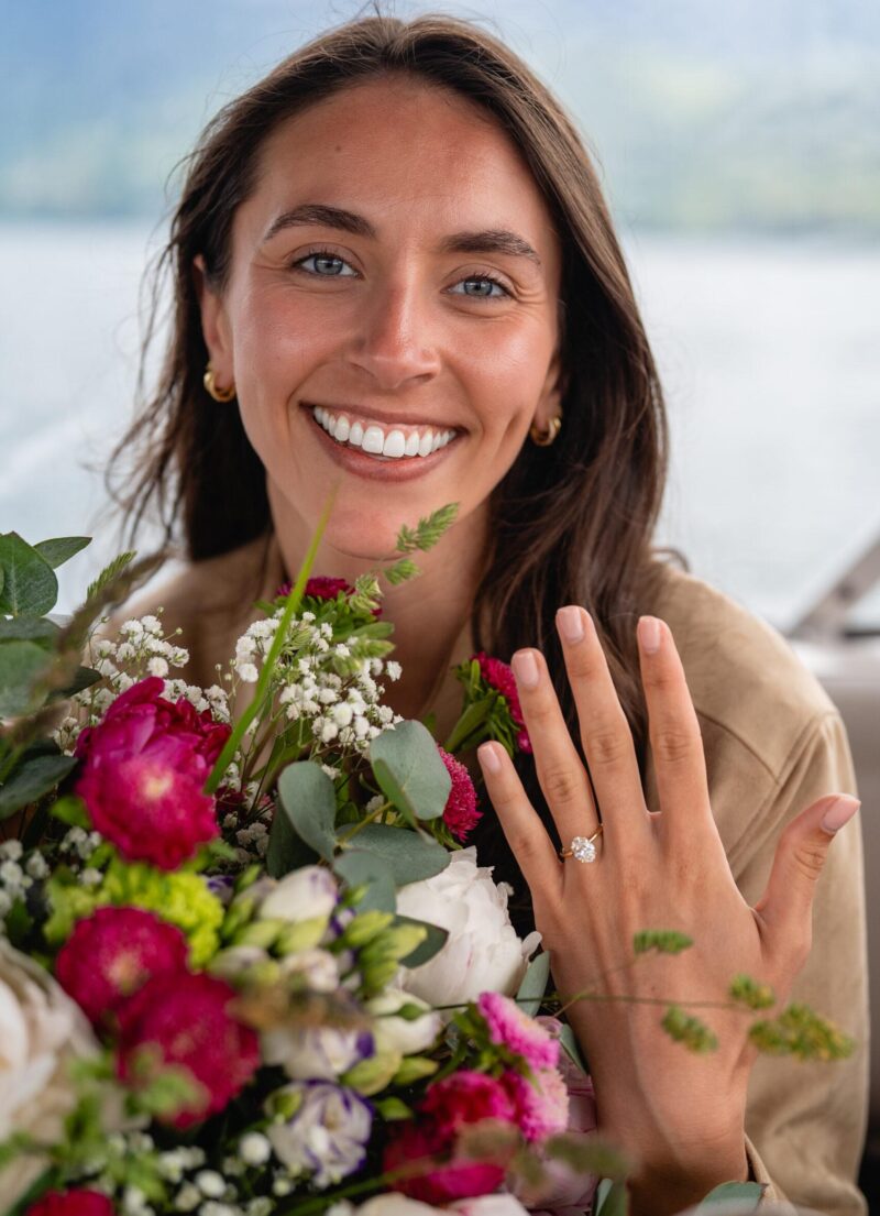 Woman smiling with engagement ring after Swiss lake proposal