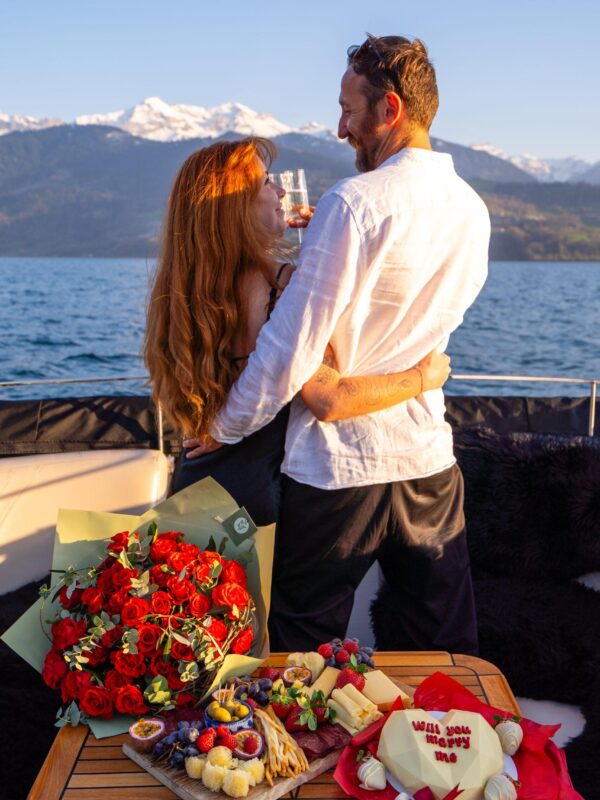 Couple embracing on romantic Lake Thun proposal cruise